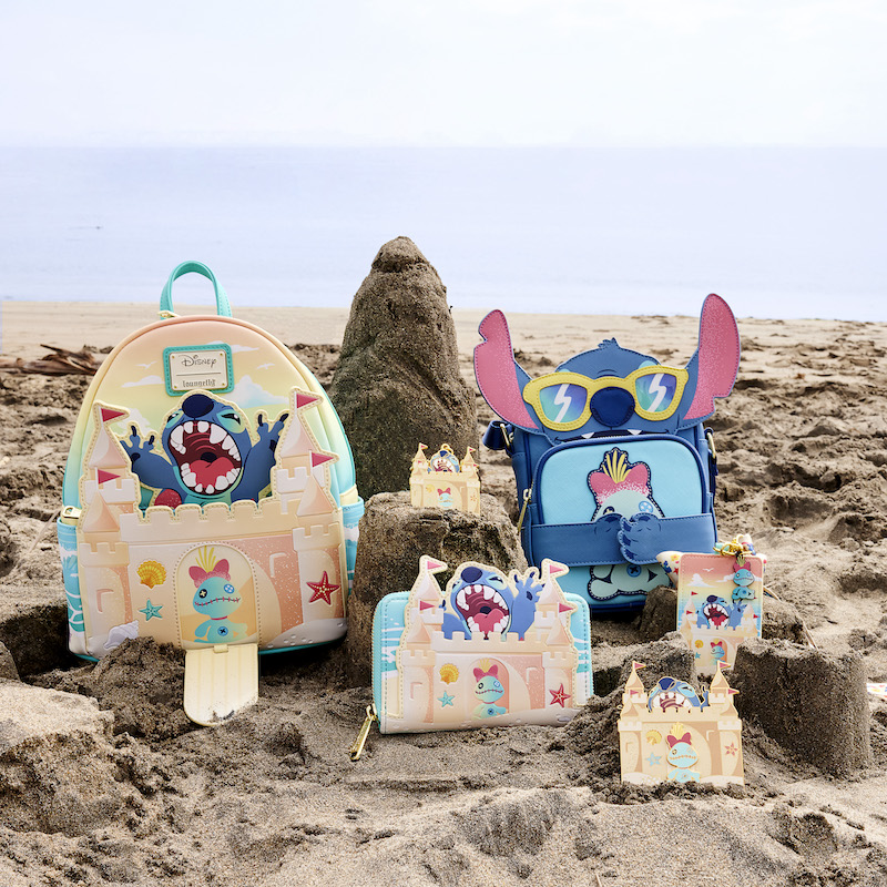 Beach scene featuring the Stitch Sandcastle Surprise backpack, wallet, cross buddies bag, pin, and lanyard